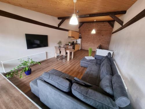 a living room with a large couch and a dining room at SAV Ferienwohnung in Erfurt