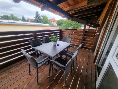 a patio with a table and chairs on a deck at SAV Ferienwohnung in Erfurt