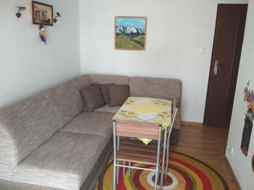 a living room with a couch and a table at J&K Štrba in Poprad