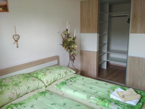 ein kleines Schlafzimmer mit einem Bett und einem Spiegel in der Unterkunft J&K Štrba in Poprad