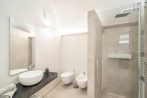 a bathroom with a sink and a toilet and a shower at Palazzo Trevignane appartamento La Saletta Verde in San Felice del Benaco