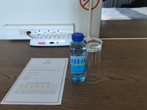 a bottle of water sitting on a table with a thermometer at The Paralian Exclusive Guest House in East London