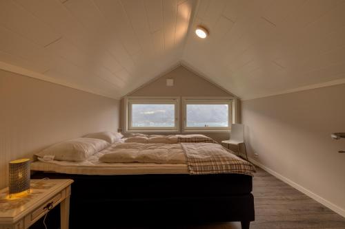 a bedroom with a large bed in a attic at Flotunet - Jørnhuset in Stryn