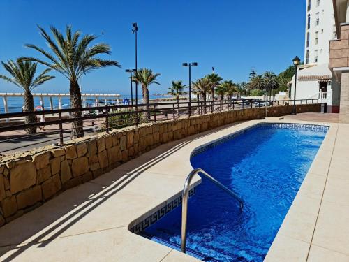 a swimming pool with the beach in the background at PARADISE SUITES Buenavista Beach in Fuengirola