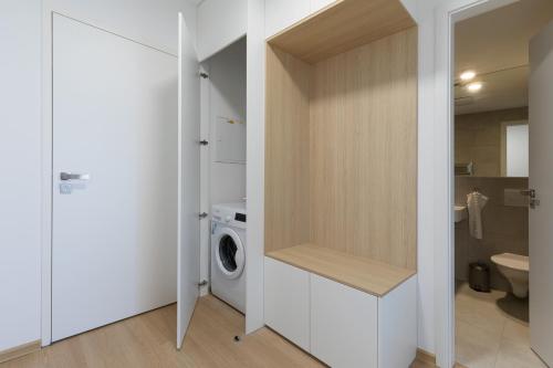 a bathroom with a washer and dryer next to a washing machine at RASL House in Luka nad Jihlavou
