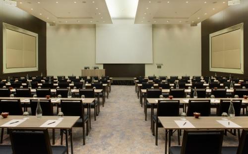 a large room filled with tables and chairs at InterContinental Lisbon, an IHG Hotel in Lisbon