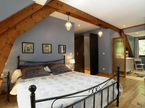 a bedroom with a large bed in a attic at Maison Rustique Familiale en Sologne avec Grands Espaces, Proche Châteaux de la Loire - FR-1-590-1 in Ardon