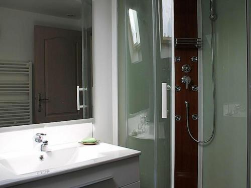 a bathroom with a sink and a glass shower at Gîte Senonches, 3 pièces, 4 personnes - FR-1-581-74 in Senonches