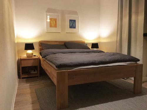 ein Schlafzimmer mit einem Bett mit zwei Lampen und zwei Tischen in der Unterkunft Zu Gast im Wohnpark Erlabrunn in Erlabrunn