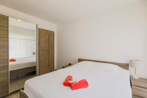 a bedroom with a white bed and a mirror at SUEDE 2 AP4208 By Riviera Holiday Homes in Nice