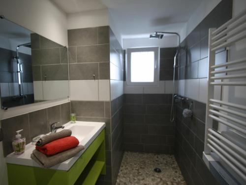 a bathroom with a sink and a shower at Gîte Vincey, 2 pièces, 2 personnes - FR-1-589-262 in Vincey