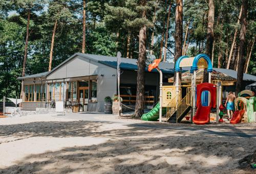 a playground in front of a building at Domki-Temar Kompleks Wypoczynkowy in Dąbie