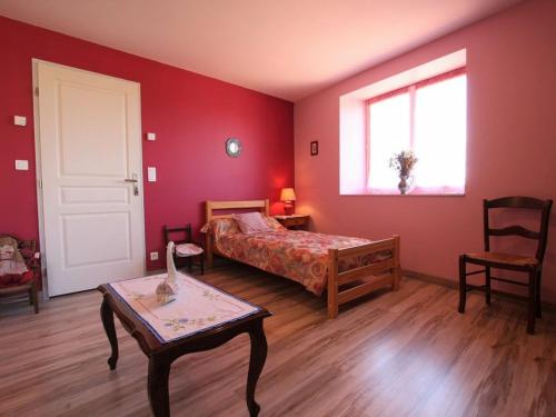 a bedroom with a bed and a table and a window at Gîte Rauret, 4 pièces, 7 personnes - FR-1-582-203 in Rauret