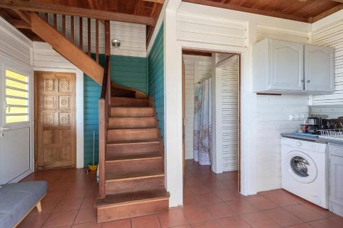 a hallway with a staircase in a house at Le Palma Christi in Le Carbet