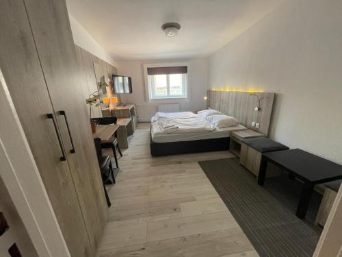 a bedroom with a bed and a table and benches at Pension Der Kretaner in Berlin