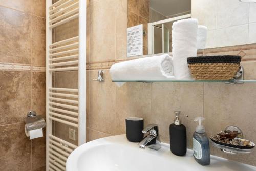 a bathroom with a sink and a mirror at Ponent 602 in Marina Portorož by Locap Group in Portorož