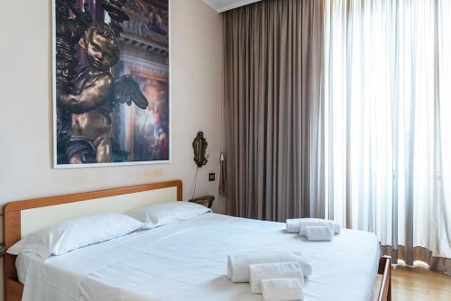 a bedroom with a bed with two towels on it at TIBERINA APARTMENTS - ROME TRASTEVERE in Rome