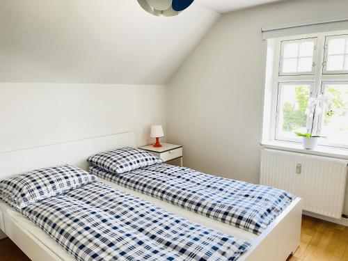 two beds in a bedroom with a window at aday - City Central Mansion - 4 bedroom apartment in Aalborg