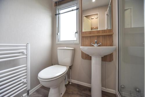 a bathroom with a toilet and a sink and a window at Hope View at Ashbourne Heights in Ashbourne