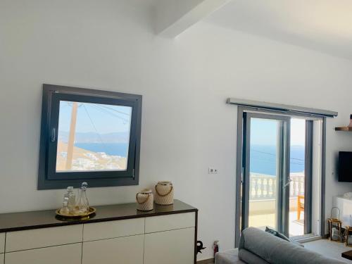 a living room with a mirror and a couch at Gerani Deluxe Houses 2 in Astypalaia Town