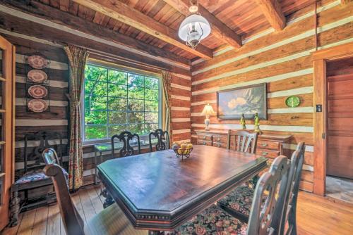 a dining room with a table and chairs in a cabin at Rustic Dover Retreat with Porch - Walk to Boat Ramp! in Dover