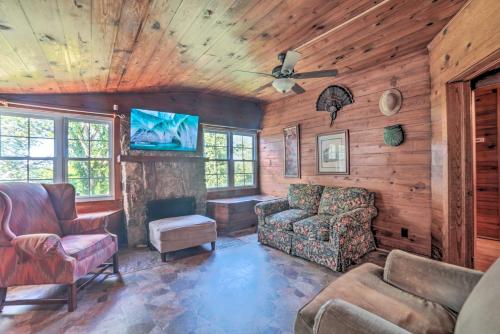 a living room with wooden walls and a ceiling at Rustic Dover Retreat with Porch - Walk to Boat Ramp! in Dover