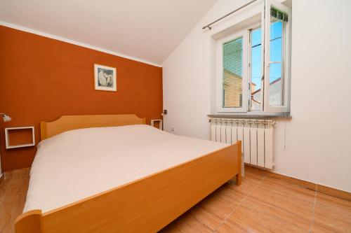 מיטה או מיטות בחדר ב-Apartmani Loreta