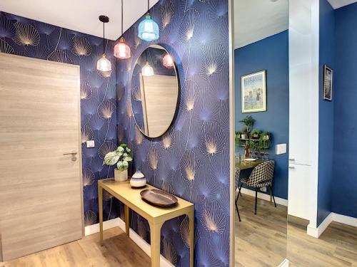 a room with a table and a mirror on a purple wall at Coeur Vieux Nice - Place Rossetti in Nice
