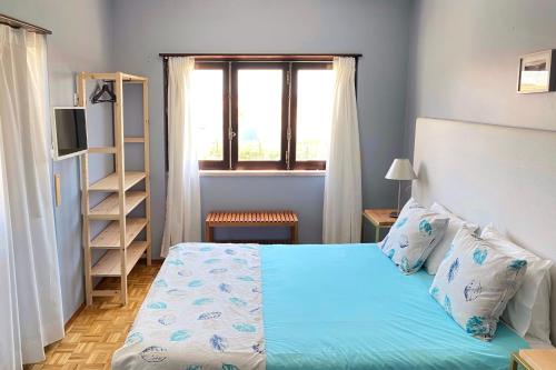 Ένα ή περισσότερα κρεβάτια σε δωμάτιο στο O Tourinho Baleal
