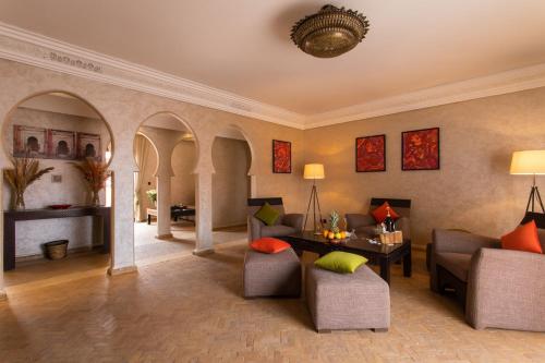 a living room with a couch and a table at Dellarosa Boutique Hotel and Spa in Marrakech