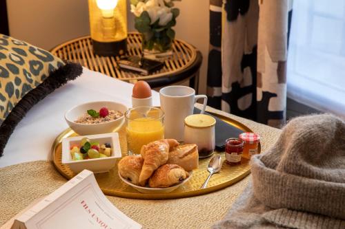 a tray of breakfast food on a table at Grand Hôtel Chicago in Paris