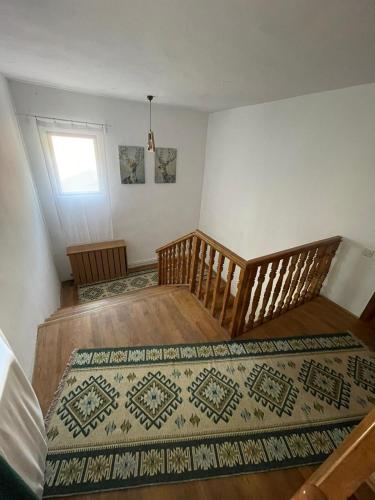 a room with a bed and a rug on the floor at Cabana Laptici - statiunea Pestera-Padina, Bucegi in Sinaia