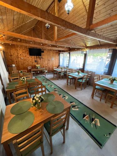 a large room with tables and chairs in a barn at Cabana Laptici - statiunea Pestera-Padina, Bucegi in Sinaia