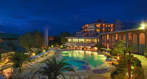 a swimming pool in front of a building at night at Hotel Terme Capasso in Contursi
