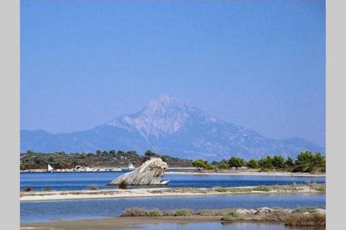 a mountain in the middle of a body of water at Nefolia in Vourvourou