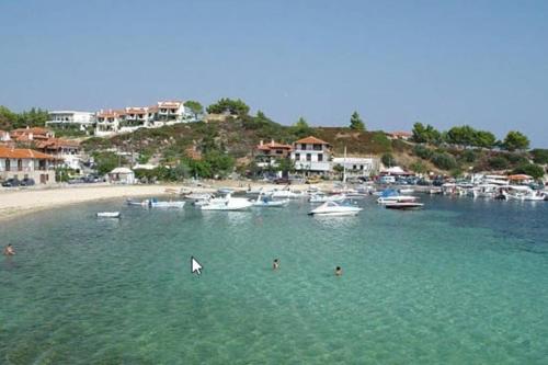 a group of people in the water near a beach at Nefolia in Vourvourou