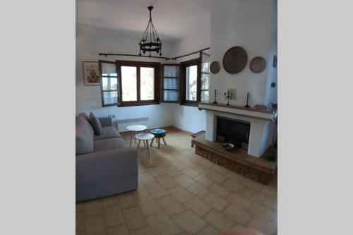 a living room with a couch and a fireplace at Nefolia in Vourvourou