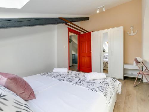 a bedroom with two beds and a red door at FantAttic apartment city center in Poreč