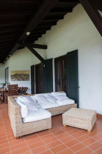 a patio with wicker couches and chairs on a house at Da Noi Due in Bergamo