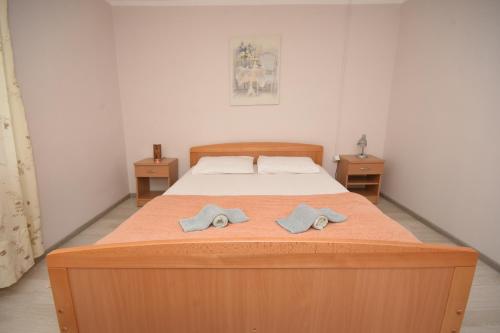 a bedroom with a bed with two towels on it at Village house Borozan in Cetinje