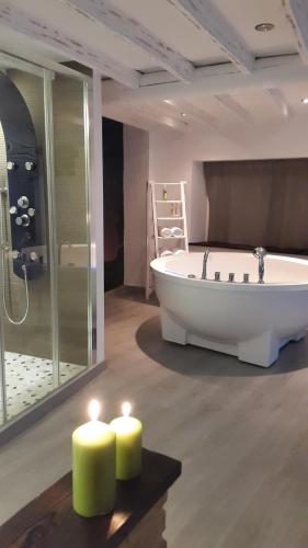 a large bathroom with a tub and two candles at La estrella del viajero in Casas del Abad