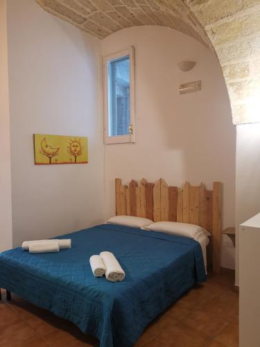 a bedroom with a bed with two towels on it at B&B La volta di Fabio De Marco e Simona Saracino in San Pietro Vernotico