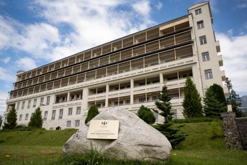 a large building with a rock in front of it at Hotel Granit Nová Polianka*** - klimatické kúpele in Vysoké Tatry