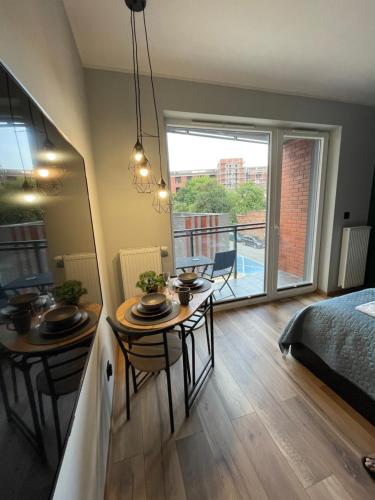 a room with a table and two chairs and a bed at Labar Apartments in Gdańsk