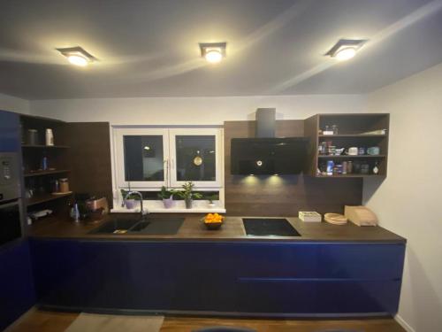 a kitchen with a blue island in a room at Kuća za odmor Evolo in Skrad