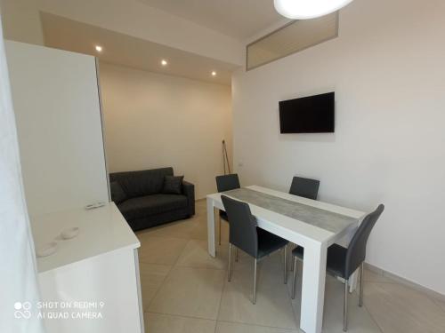 a kitchen and dining room with a table and chairs at Royal View Apartment in Cefalù