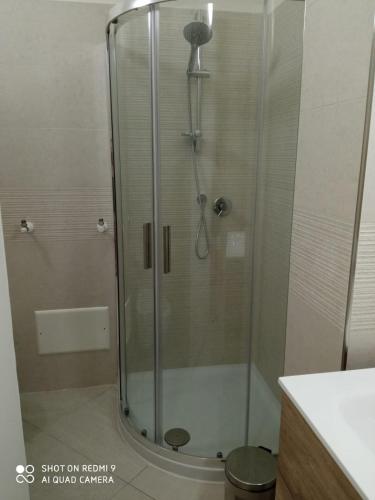 a shower with a glass door in a bathroom at Royal View Apartment in Cefalù