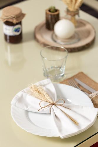 a white plate with a bow on a table at Kuk Medin in Klanac