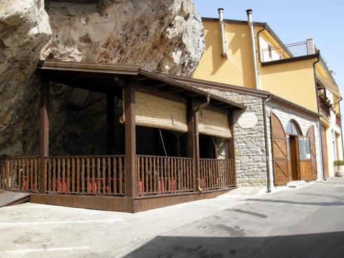 a building with a balcony next to a mountain at Delfino in Pietrapertosa