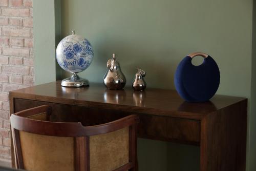 a table with a blue and white vase on it at Gaia Lodge in Tupungato